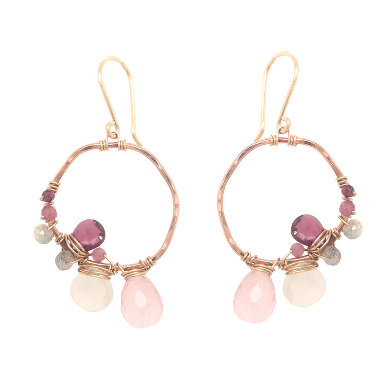 Gold and rose gold hoop earrings with asymmetrical gemstone wraps including rose quartz, moonstone, and rhodolite garnet