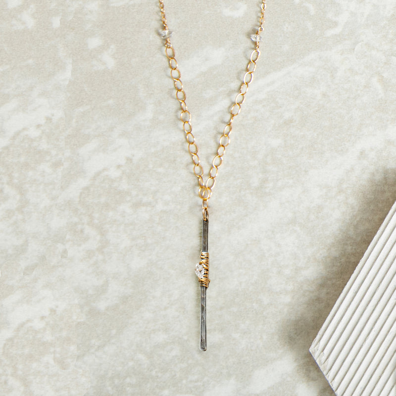 Sterling silver gunmetal finish vertical bar pendant with gold wraps and herkimer diamonds