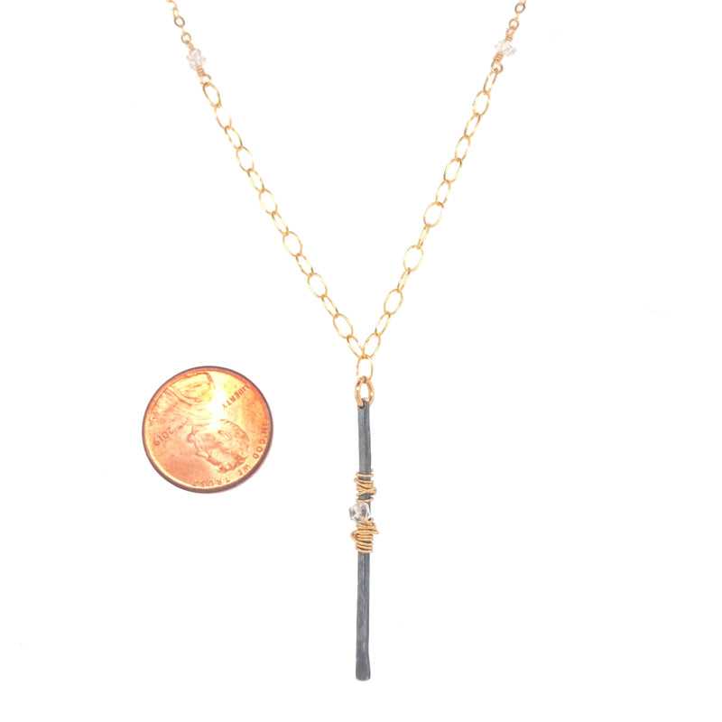 Bar pendant necklace with penny for scale