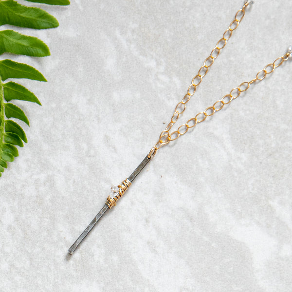 Sterling silver gunmetal finish vertical bar pendant with gold wraps and herkimer diamonds