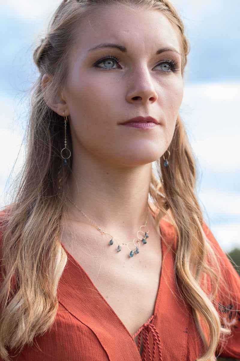 Gold hoop and chain earring with kyanite drop on model